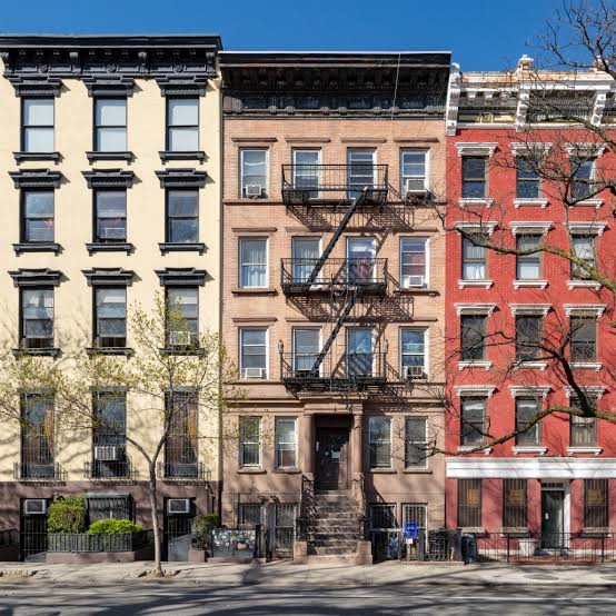 Row of classic urban brownstone apartment buildings managed by the Best Property Management Companies.