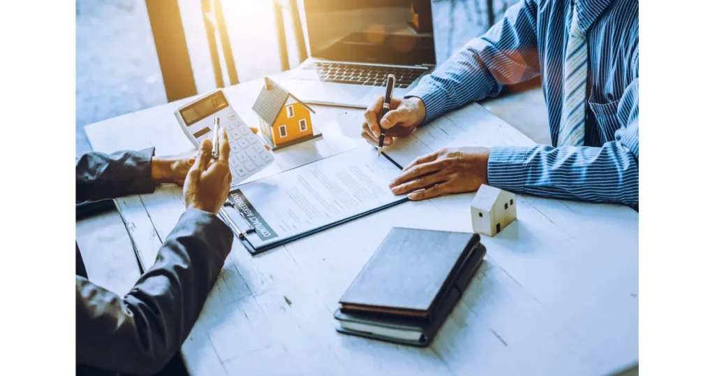 Property Management Solutions expert reviewing lease agreements and rental property documents with clients to streamline property operations.