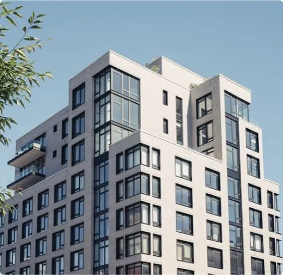 A sleek, modern multi-story NYC apartment building facade, an ideal property for professional Real Estate Management NYC.